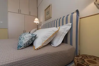a bedroom with a bed with pillows on it at Absolute Athens III in Athens