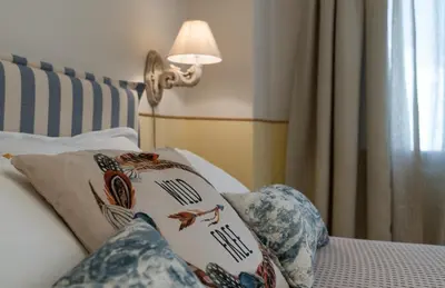 a bed with a lamp and pillows on it at Absolute Athens III in Athens