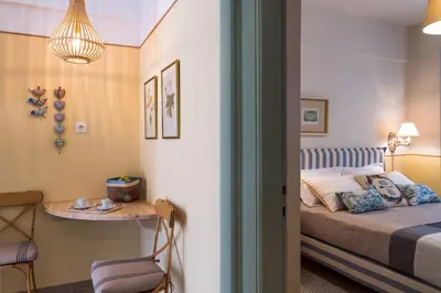 a small bedroom with a bed and a table at Absolute Athens III in Athens