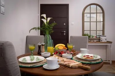 a wooden table with food and drinks on it at Absolute Athens III in Athens