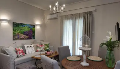 a living room with a couch and a table at Absolute Athens III in Athens