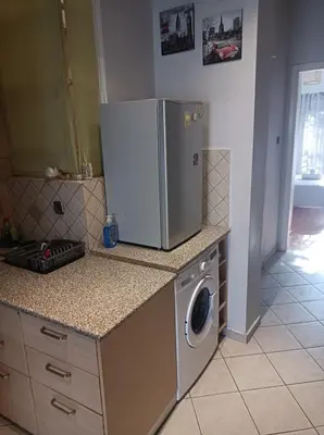 a kitchen with a refrigerator and a washing machine at Historic Center Apartment at Thisseio in Athens