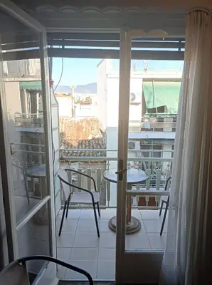 a balcony with a view of a table and chairs at Historic Center Apartment at Thisseio in Athens