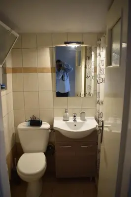 a bathroom with a toilet and a sink and a mirror at Historic Center Apartment at Thisseio in Athens