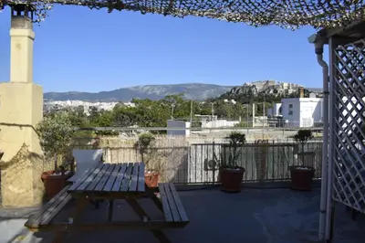 a patio with a picnic table on a balcony at Historic Center Apartment at Thisseio in Athens
