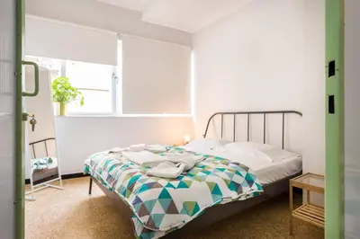 a bedroom with a bed and a window at Delfini Home Plaka/Acropolis in Athens