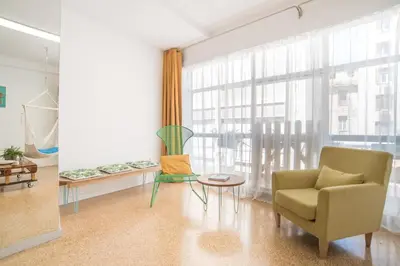 a living room with a chair and a table at Delfini Home Plaka/Acropolis in Athens
