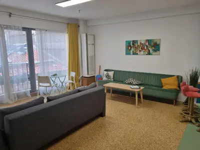 a living room with a couch and a table at Delfini Home Plaka/Acropolis in Athens
