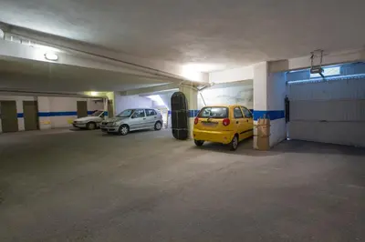 a parking garage with two cars parked in it at Zeas Apartment in Piraeus