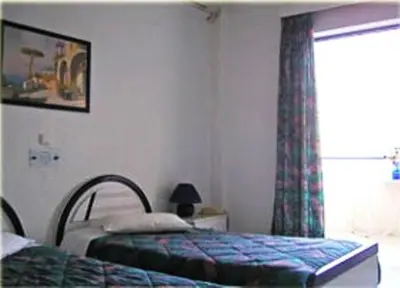 a bedroom with two beds and a window at Anna Studios in Agia Marina Aegina