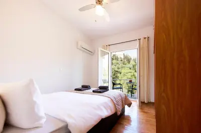 a bedroom with a bed and a large window at Unique views of Filopapou hill in Acropolis Area! in Athens