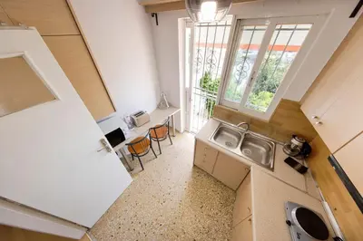 a small kitchen with a sink and a window at Unique views of Filopapou hill in Acropolis Area! in Athens