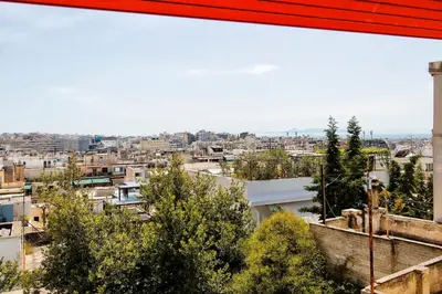a view of a city from a building at Unique views of Filopapou hill in Acropolis Area! in Athens