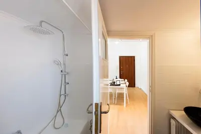a bathroom with a shower stall and a kitchen at Unique views of Filopapou hill in Acropolis Area! in Athens