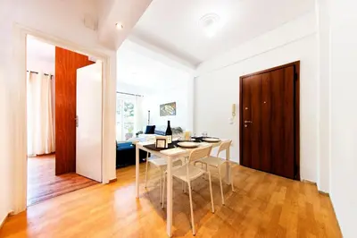 a dining room with a table and chairs in a room at Unique views of Filopapou hill in Acropolis Area! in Athens