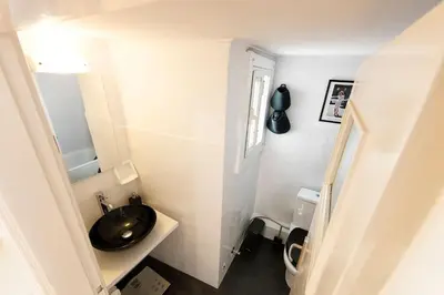 a bathroom with a black sink and a toilet at Unique views of Filopapou hill in Acropolis Area! in Athens