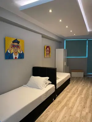 a room with two beds and a painting on the wall at Connect Studios & Apartments in Athens