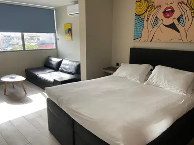 a bedroom with a large bed and a couch at Connect Studios & Apartments in Athens