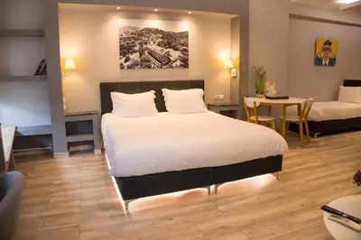 a hotel room with a bed and a table and a room at Connect Studios & Apartments in Athens