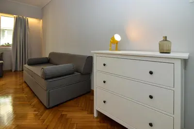a living room with a dresser and a couch at Athens' heart Syntagma metro apartment in Athens