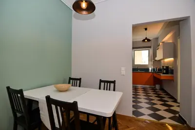 a kitchen and dining room with a white table and chairs at Athens' heart Syntagma metro apartment in Athens