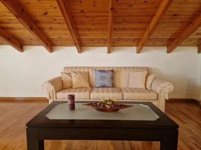 a living room with a couch and a coffee table at The Mirador Boutique Villa with Scenic Sea View in Porto Rafti