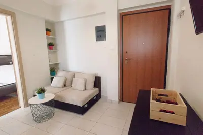 a living room with a couch and a wooden door at Athens City Themis 3 in Athens