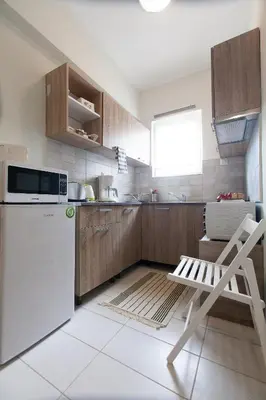 a kitchen with a white refrigerator and a chair at Athens City Themis 3 in Athens