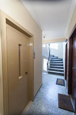 a hallway with a door and stairs in a building at Athens City Themis 3 in Athens