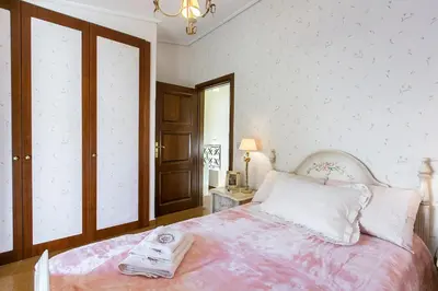 a bedroom with a bed with a robe on it at Villa Melia Athenian Riviera in Sounio