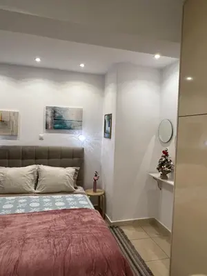 a bedroom with a bed with a red blanket at Porto Rafti view by Akroploro in Porto Rafti