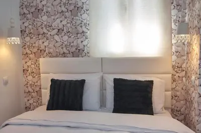 a bedroom with a white bed with two black pillows at Signature Athens Residence, 130 sqm, Near Metro in Athens
