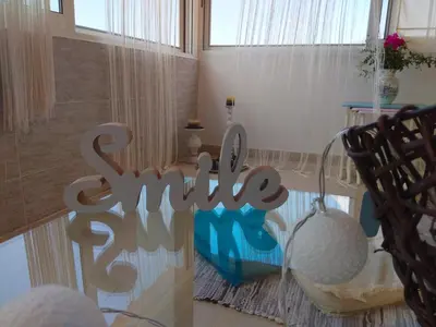 a room with a glass table and chairs and a sign at Outstanding Panoramic View, 10΄ beach, 20΄ airport in Ólimbos