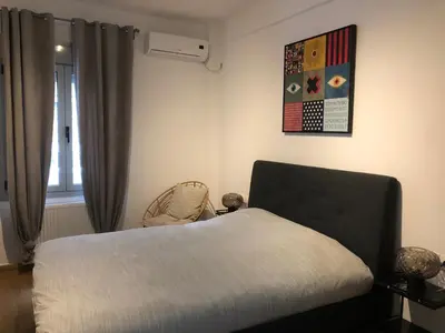 a bedroom with a bed and a window at Exarcheia House in Athens