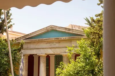 an old building with a flag in front of it at Hadrian by Heloni Apartments in Athens