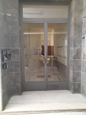 a glass door of a building with a room at Hadrian by Heloni Apartments in Athens
