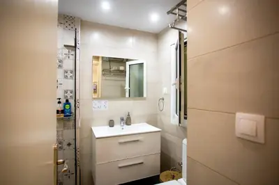 a small bathroom with a sink and a shower at Hadrian by Heloni Apartments in Athens