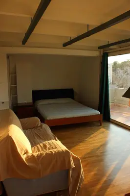 a bedroom with two beds and a large window at Acropolis view penthouse in Athens