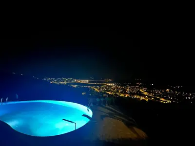 a view of a city at night at Endless Blue in Anavissos