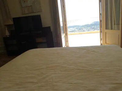 a bedroom with a bed and a large window at Endless Blue in Anavissos