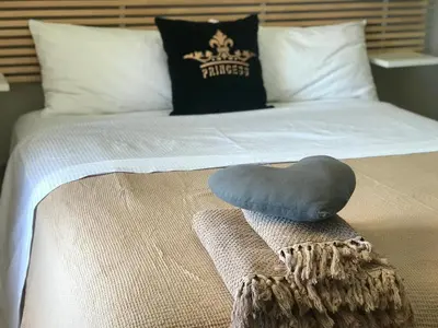a bed with a pillow on top of it at Endless Blue in Anavissos