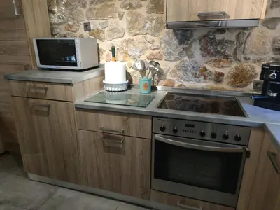a kitchen with a stove and a microwave at Stone House in Athens