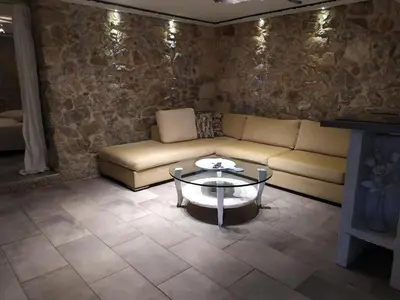 a living room with a couch and a table at Stone House in Athens