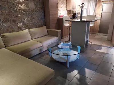 a living room with a couch and a table at Stone House in Athens