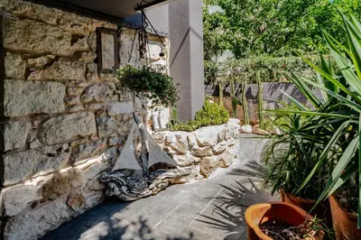 a stone wall with potted plants on it at Stone House in Athens