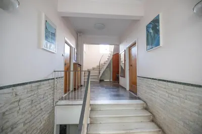 a hallway of a building with stairs and a wall at Top sightseeing 3rd floor studio on a paved road! in Athens