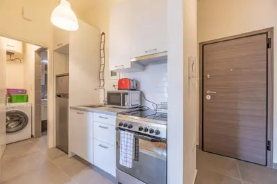 a kitchen with a stove and a microwave at Top sightseeing 3rd floor studio on a paved road! in Athens