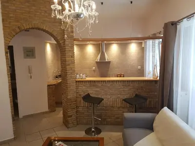 a living room with a couch and a bar at JOHN BEAUTY 50m2, METRO and ACROPOLIS 5' in Athens