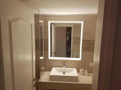 a bathroom with a white sink and a mirror at JOHN BEAUTY 50m2, METRO and ACROPOLIS 5' in Athens