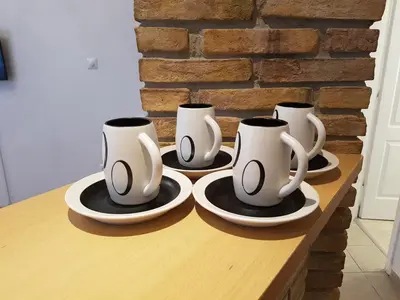 a row of coffee mugs sitting on a table at JOHN BEAUTY 50m2, METRO and ACROPOLIS 5' in Athens
